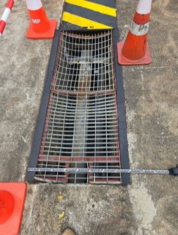 Heavy-duty drain cover installation with traffic cones