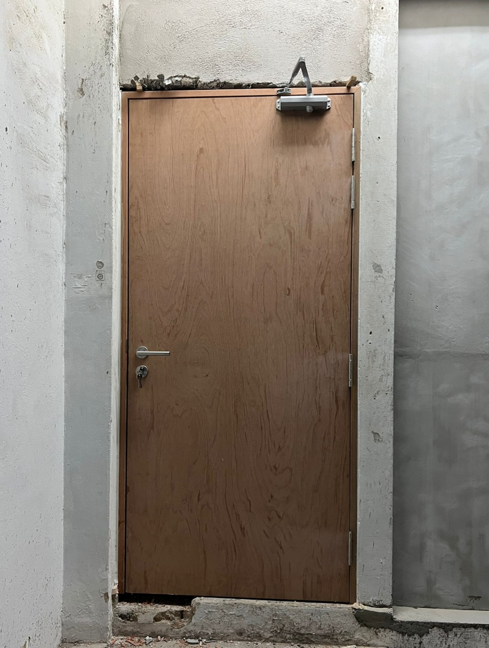 Fire-rated door installation with closer and signage