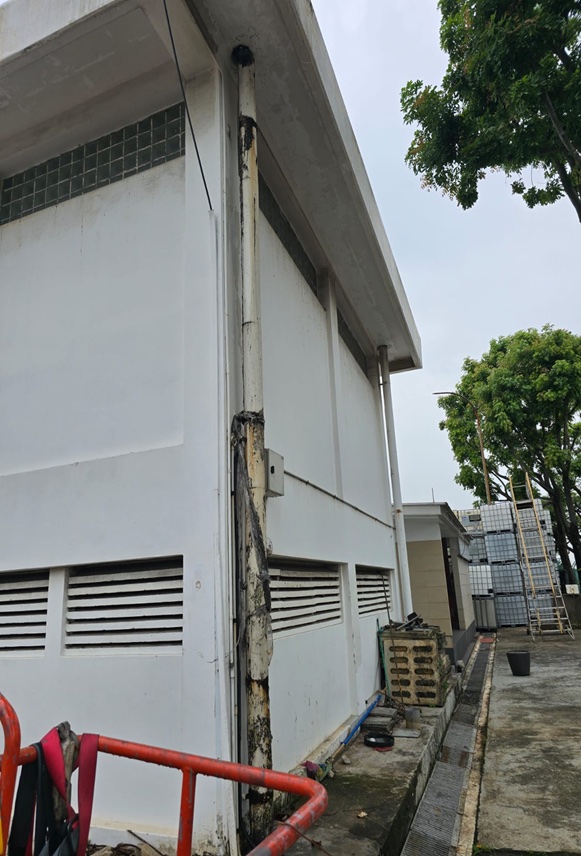 Building facade with new rainwater down pipe installation