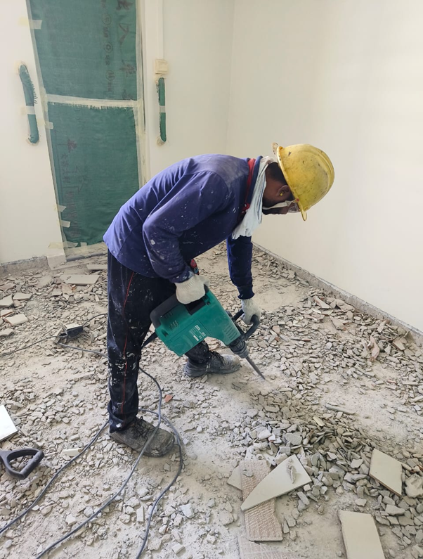 Worker performing HDB hacking with jackhammer