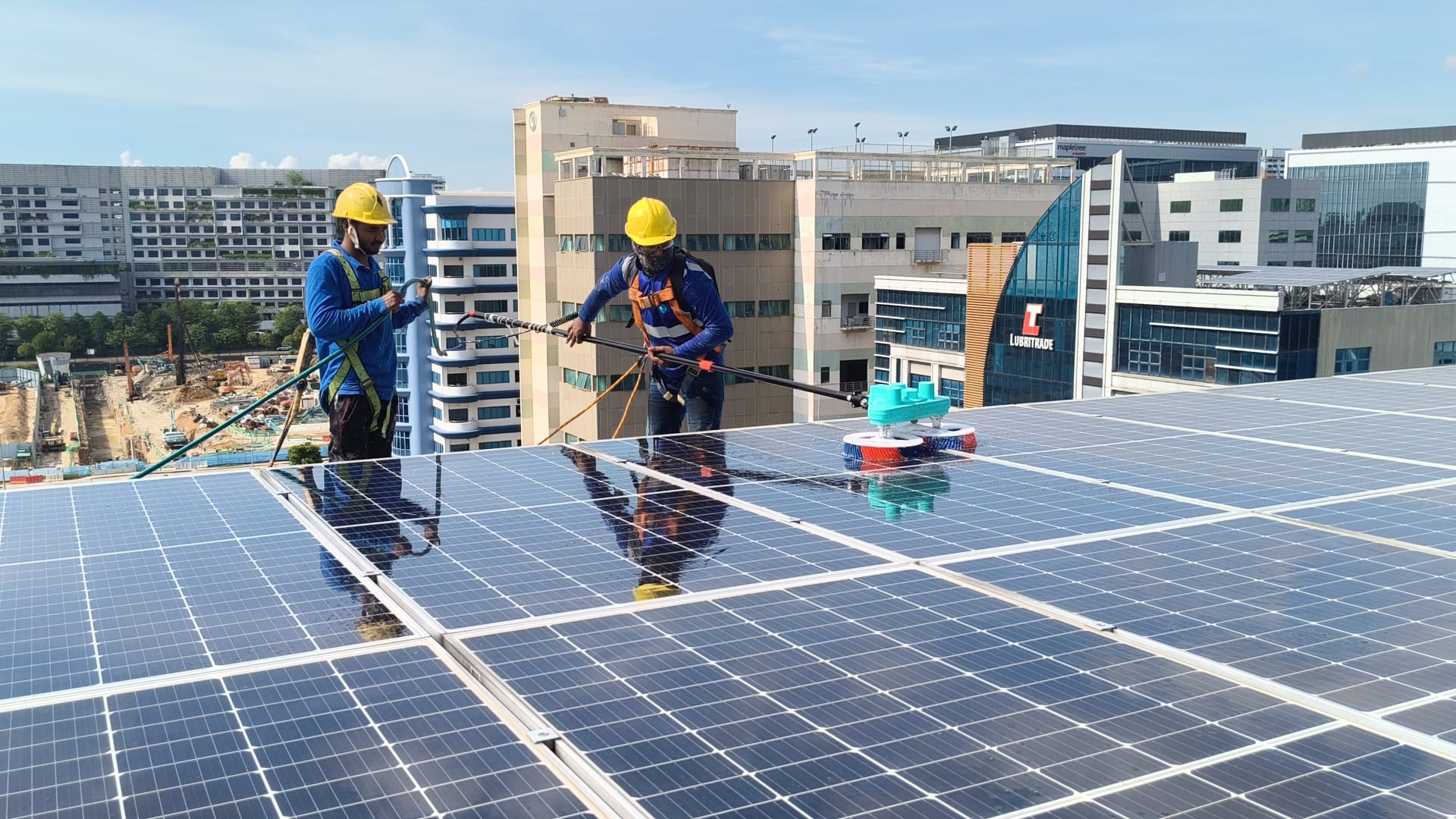 ASU team performing solar panel cleaning and maintenance on rooftop PV array